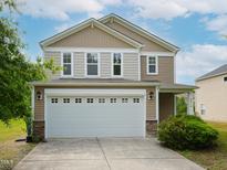 Charming two-story home featuring a two-car garage and manicured landscaping at 3515 Mountain Brook Cir, Durham, NC 27704