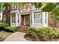 Charming brick home with a bright green front door, bay windows and manicured landscaping creating a welcoming entrance at 3928 Bentley Bridge Rd, Raleigh, NC 27612