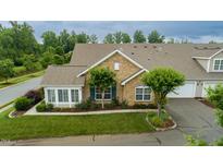 Attractive condo with stone front, lush landscaping and an attached garage at 425 Faith Dr, Gibsonville, NC 27249