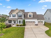 Charming two-story home featuring a three-car garage and well-manicured lawn at 44 Good Morning Ln, Garner, NC 27529