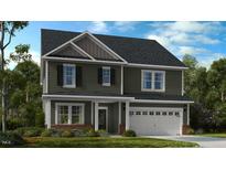 Charming two-story home featuring a two-car garage and lush landscaping, providing an inviting curb appeal at 523 Claftin St, Sanford, NC 27330