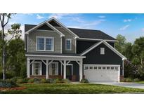 Charming two-story home featuring a covered porch, gray siding, and an attached two-car garage at 547 Claftin St, Sanford, NC 27330