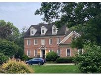 Charming two-story brick home with symmetrical windows and lush landscaping offering excellent curb appeal at 605 Lake Boone Trl, Raleigh, NC 27607