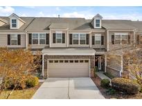 Charming townhome featuring a two-car garage and beautiful exterior finishes at 635 Grace Hodge Dr, Cary, NC 27519