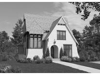 Charming white brick home featuring elegant arched entryway, well-manicured landscaping, and a classic Tudor-style architectural design at 918 N Blount St, Raleigh, NC 27604