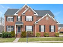 Beautiful two-story brick home with black shutters and manicured landscaping at 930 Pristine Ln, Rolesville, NC 27571