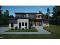 Stunning modern home with a sleek design, mixed materials, and manicured landscaping for curb appeal at 10 Gambel Dr, Youngsville, NC 27596