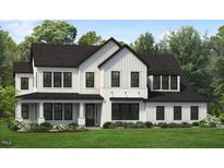 Stunning modern farmhouse with white siding, black trim, and a manicured lawn at 1025 Overdrift Ln, Cary, NC 27519