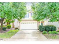 Charming two-story home featuring a two-car garage and manicured front yard with mature trees at 145 Torrey Heights Ln, Durham, NC 27703