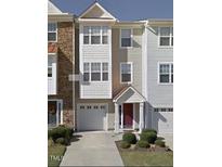 Charming townhome featuring an attached one-car garage, private entrance, and neutral exterior paint scheme at 1527 Haywards Heath Ln, Apex, NC 27502