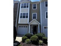 Charming townhome with attached garage, well-kept landscaping, and inviting front entrance at 1527 Haywards Heath Ln, Apex, NC 27502