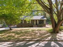 Charming one-story home with green siding and a well-maintained front lawn under a shady tree at 216 Burkwood Ln, Raleigh, NC 27609