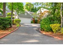 Charming home featuring a well-manicured front yard and a spacious driveway leading to a two-car garage at 2205 Landings Way, Raleigh, NC 27615
