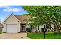 Charming single-story home featuring an attached two-car garage and manicured front lawn at 305 Slate Dr, Gibsonville, NC 27249