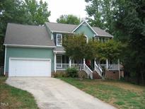 Charming two-story home featuring a white two-car garage, porch, and well-maintained landscaping at 3511 Shady Creek Dr, Durham, NC 27713