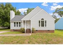 Charming single-story home with gray siding, chimney and a well-manicured front lawn at 71 E Boxley Dr, Wendell, NC 27591