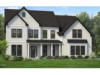 Charming two-story home features a covered entry, black framed windows, and a beautifully landscaped front yard at 805 Timber Mist Ct, Cary, NC 27519