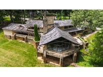 Stunning home with stone and wood exterior, a unique design, and a spacious outdoor deck at 812 Kenmore Rd, Chapel Hill, NC 27514