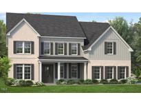 Charming two-story home with a beautifully landscaped yard and a welcoming front porch at 812 Timber Mist Ct, Cary, NC 27519