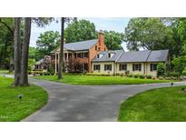 Expansive estate home featuring mature trees, manicured lawn, and circular driveway at 820 Kenmore Rd, Chapel Hill, NC 27514
