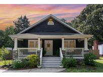 Charming home featuring a covered front porch and landscaped yard, perfect for enjoying the outdoors at 109 St Marys St, Garner, NC 27529
