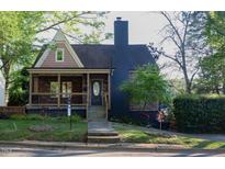 Charming two-story home with a covered porch and a well-manicured lawn at 119 W Vernon Ave, Wake Forest, NC 27587