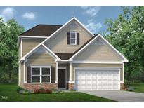Charming two-story home with stone accents, well-maintained landscaping, and an attached two-car garage at 157 Mildred Pl, Broadway, NC 27505