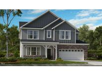 Charming two-story home with stone accents, a covered porch, and a two-car garage, perfect for modern living at 1701 Clydner Dr, Apex, NC 27523