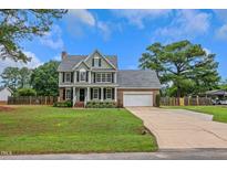 Charming two-story home with an attached garage, inviting front porch, and well-manicured lawn at 248 Robin Loop, Dunn, NC 28334