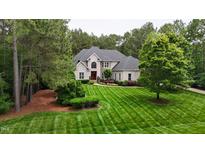 Stunning brick home with meticulously striped lawn and mature landscaping offering great curb appeal at 3004 Krogen Ct, Creedmoor, NC 27522