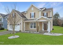 Charming two-story home with a well-manicured lawn and a two-car garage at 800 Tree Green Ln, Wake Forest, NC 27587