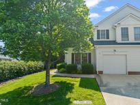 Charming two-story home featuring a manicured lawn and a single-car garage at 1 Lake Hill Dr, Durham, NC 27713