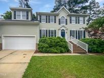 Charming two-story home featuring an attached garage, manicured lawn, and elegant landscaping at 120 Point Harbor Dr, Cary, NC 27519