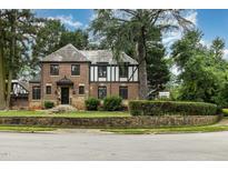 Charming brick two-story home with Tudor accents and manicured front yard in a desirable location at 1541 Caswell St, Raleigh, NC 27608
