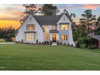 Stunning two-story white brick home with a lush lawn and beautiful landscaping at 217 Dublin Rd, Raleigh, NC 27609