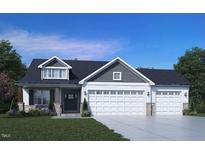 Charming two-story home featuring a three-car garage, craftsman details, and a well-manicured lawn at 221 Hillwood Dr, Sanford, NC 27332