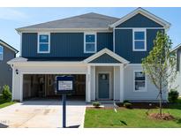 Charming two-story home with a combination of blue and white siding, with an attached garage at 2254 Cherry Creek Rd, Haw River, NC 27258