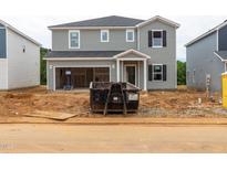 New two-story home with gray siding, an attached garage, and front yard under construction at 2258 Cherry Creek Rd, Haw River, NC 27258