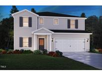 Charming two-story home with a well-manicured lawn, covered entrance, and a two-car garage at 2258 Cherry Creek Rd, Haw River, NC 27258