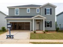 Two-story home featuring an attached garage, gray siding, black shutters, and a well-maintained front lawn at 2258 Cherry Creek Rd, Haw River, NC 27258