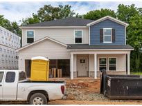 New two-story home with a two-car garage, blue and gray siding, and construction in progress at 2291 Cherry Creek Rd, Haw River, NC 27258