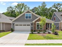 Charming single-Gathering home featuring stone accents, a two-car garage, and beautifully landscaped front yard at 248 Speight Branch Rd, Cary, NC 27518