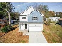 Charming two-story home features a blend of light siding and blue shingle accents at 3001 Sadie Hopkins St, Raleigh, NC 27616