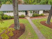 Aerial view of a charming home with landscaped front yard and mature trees at 402 Forest Rd, Oxford, NC 27565
