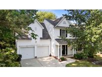 Charming two-story home featuring a two-car garage, neutral siding, and manicured landscaping at 4213 Stoneford Trace Dr, Raleigh, NC 27616