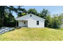 Charming single-story home with white siding, manicured lawn, and mature trees at 505 E Canary St, Dunn, NC 28334