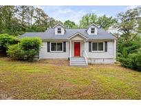 Charming home featuring a bright red front door and inviting curb appeal at 5601 Buffaloe Rd, Raleigh, NC 27616
