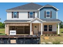 Two-story home featuring a mix of blue and white siding, black shutters, and a brick-accented foundation at 685 White Birch Ln, Angier, NC 27501