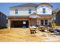 Exterior of home under construction with brick accents, showcasing unfinished facade and garage entrance at 685 White Birch Ln, Angier, NC 27501