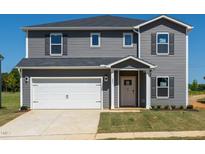 Charming two-story home featuring gray siding, a white garage door, and a well-maintained lawn at 693 White Birch Ln, Angier, NC 27501